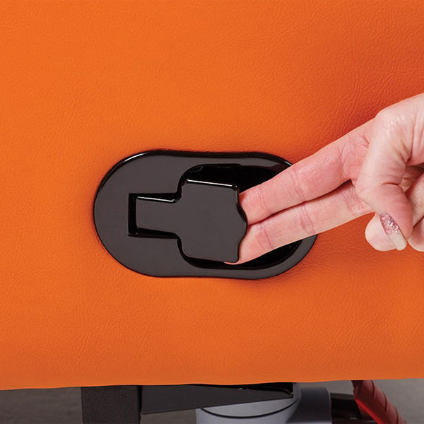 Hand operating black recliner lever on orange Boston Healthcare Chair, showing pressure relief function, side view.
