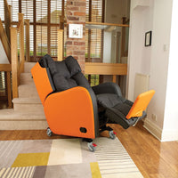 Orange and black Boston Healthcare Chair with wheels, positioned at the bottom of a carpeted staircase, side view.