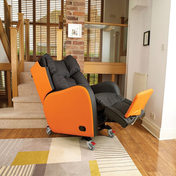 Orange and black Boston Healthcare Chair with wheels, positioned at the bottom of a carpeted staircase, side view.
