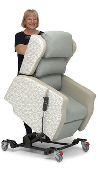 Woman standing behind Repose Seating Madison Healthcare Chair with wheels and remote control, tilt-in-space feature, front view in use.
