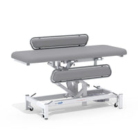 Medi-Plinth electric changing table with MRSA-resistant upholstery, side rails, wheels and padded surface, side view.