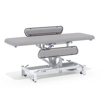 Electric changing table with side rails, MRSA-resistant upholstery and sturdy wheeled frame, front view.