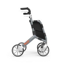 Black rollator walker with four wheels, ergonomic handles and a shopping bag, front view.