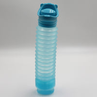 Buckingham Uriwell Unisex Urinal, collapsible plastic with ridged body and closed flip-top lid, upright on plain background, front view.
