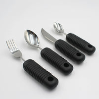 Four Homecraft Sure Grip Bendable Utensils with large ribbed handles arranged in a row on a white surface, top view.