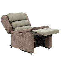 Accora Configura Comfort Chair with padded cushions, armrests, long leg rest, wheels and soft fabric, shown from a side view.