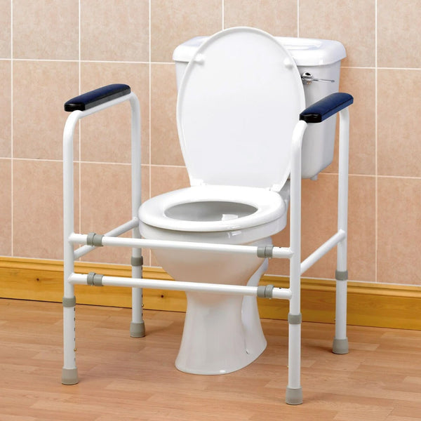 Homecraft adjustable toilet surround with height and width adjustment and padded armrests, front view.