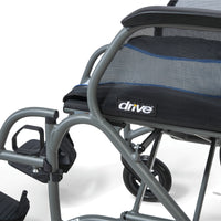Drive Aero Mg Self Propel Wheelchair with mesh seat, footrests and rear wheel, white background, close-up.