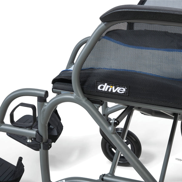 Drive Aero Mg Self Propel Wheelchair with mesh seat, footrests and rear wheel, white background, close-up.