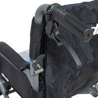 Handle and brake lever on Drive Aero Mg Transit Wheelchair backrest, close-up.