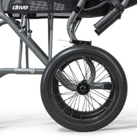 Drive Aero Mg Transit Wheelchair large black wheel and footrest on ultralight frame, close-up.