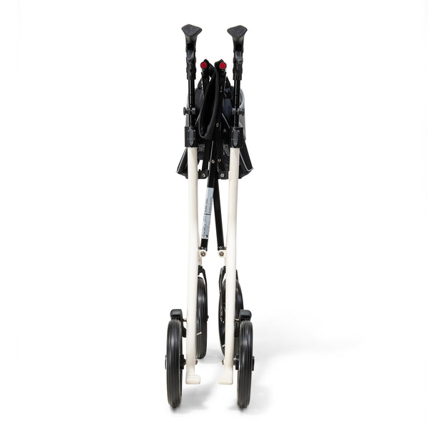Drive AeroWalk Carbon Rollator in buttercream, folded upright on its wheels, white background, side view.