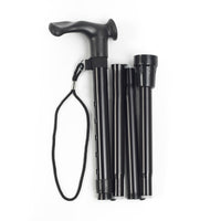 Folding aluminium right-handed walking stick with anatomic grip and wrist strap, top-down view.