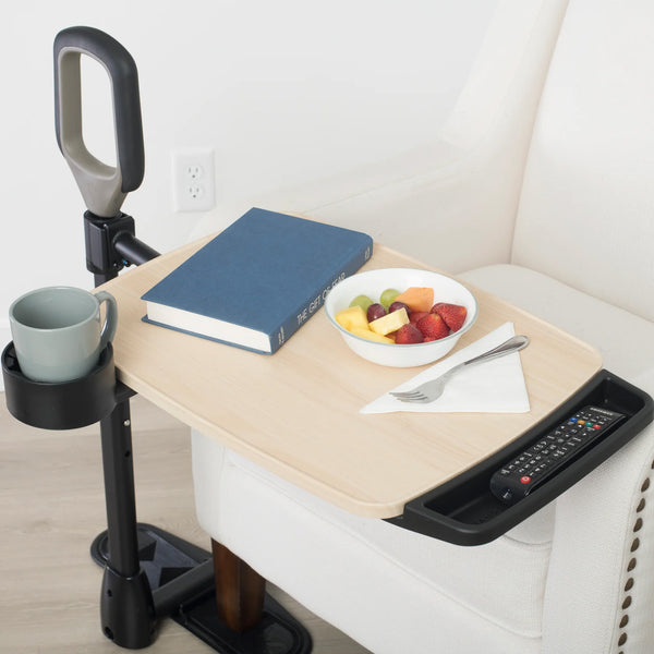 Stander Assist-A-Tray over chair table with support handle, cup holder, and side compartment, in use.