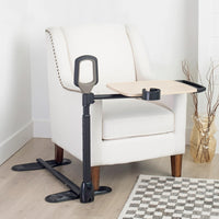 Stander Assist-A-Tray table with support handle, cup holder, and wide base feet, in use view.