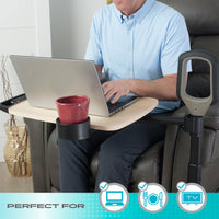 Person using a laptop on a Stander Assist-A-Tray Over Chair Table attached to an armchair, in use.