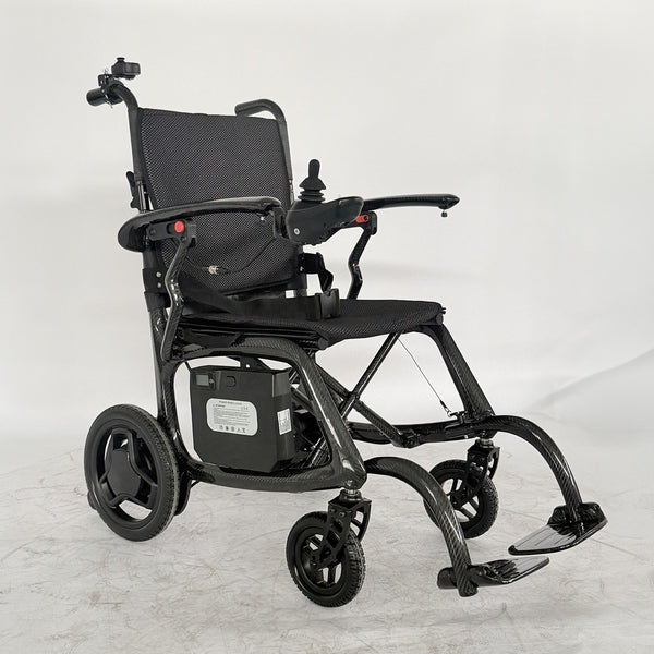 Urathon Velora Carbon Fibre Powerchair with joystick control, padded seat, armrests, footrest and battery, side view.