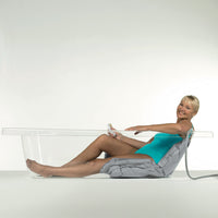 person in clear bath using bath lift. Demo when in use
