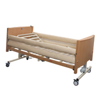 Sidhil Bradshaw Mesh Cradle profiling bed with bumpers, side rails and wheels on white background, front angle view.