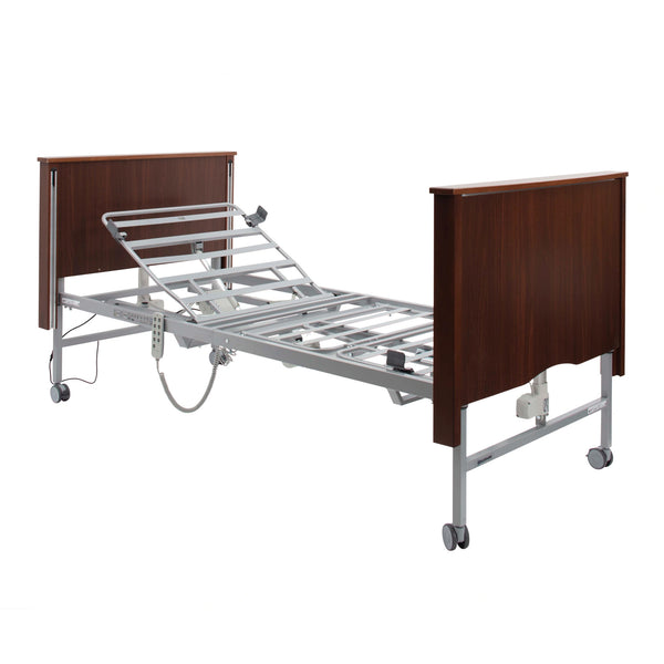 Sidhil Bradshaw electric nursing care bed with metal rails and wheels, side view.