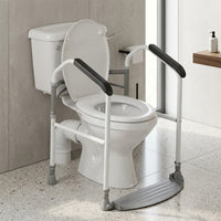 Buckingham Foldeasy Toilet Frame Surround with foot platform fitted around a toilet in a bathroom with light floor tiles, front view.