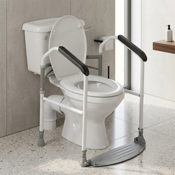 Buckingham Foldeasy Toilet Frame Surround with foot platform fitted around a toilet in a bathroom with light floor tiles, front view.
