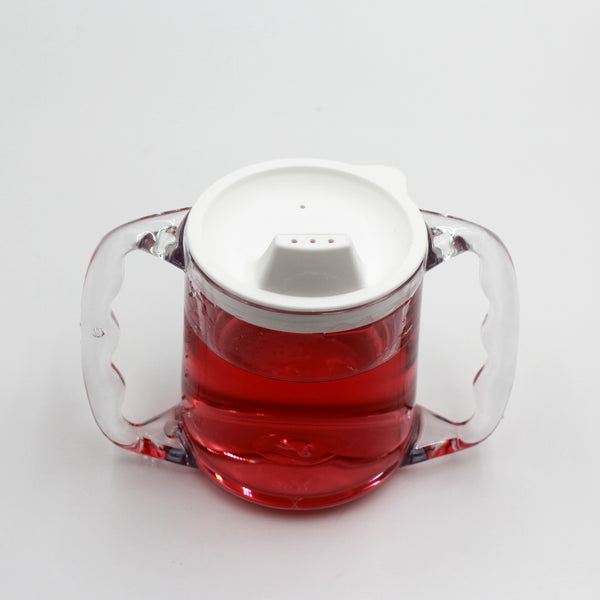 Homecraft Caring Mug with clear plastic body, angled handles, white spout lid and red liquid, on white background, front view.
