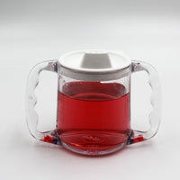 Homecraft Caring Mug with angled handles and spout lid, filled with liquid, on white background, front view.
