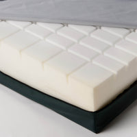 CasaFlex Mattress with grid-patterned foam core and partially removed cover, close-up.