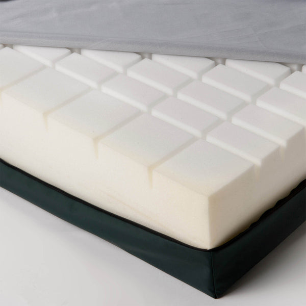 CasaFlex Mattress with grid-patterned foam core and partially removed cover, close-up.