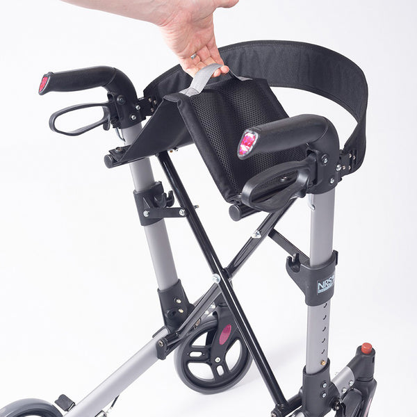 NRS Compact Easy Rollator being lifted by the seat handle to show foldable, compact design, in use close-up.