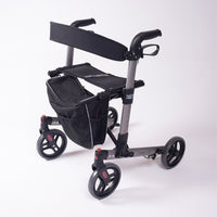 NRS Compact Easy Rollator foldable 4-wheel walker with seat and storage bag, side view.