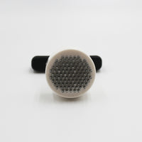Homecraft Contour Knob Turner with metal bristles and black handle for turning knobs, shown from the side.