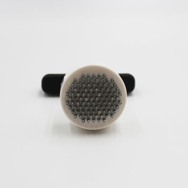 Homecraft Contour Knob Turner with metal bristles and black handle for turning knobs, shown from the side.