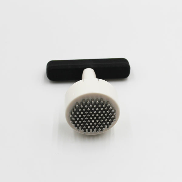 Homecraft Contour Knob Turner with round spiked end and grip handle, on a white surface, close-up view.