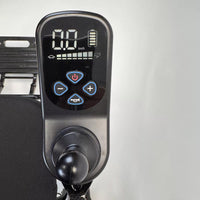 Dash Rehab Dash Carbon Max HD Power Chair digital panel showing 0.0 km/h with control buttons and joystick, close-up view.