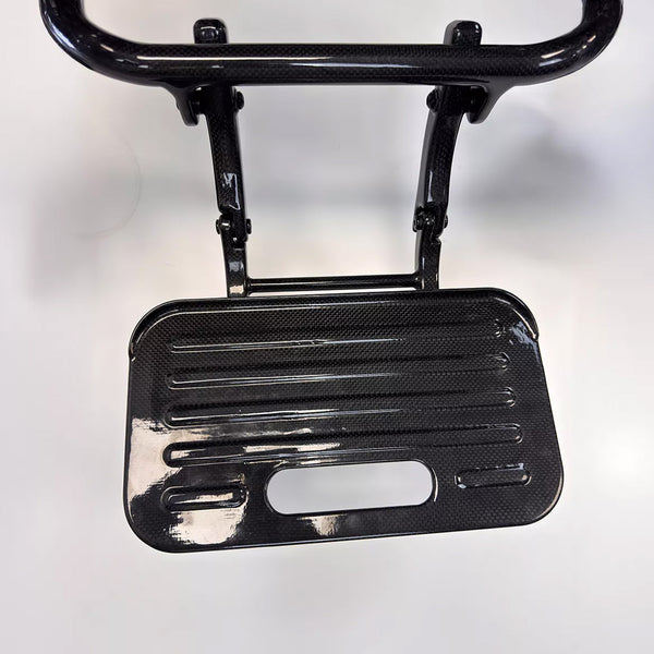 Dash Rehab footrest with textured surface and handle for Dash Carbon Max HD Power Chair, top view on white background.
