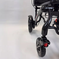 Dash Rehab Dash Carbon Max HD Power Chair front wheels and frame on plain background, close-up.
