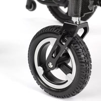 Caster wheel with textured rubber tyre on Dash Carbon Pro Plus Powerchair, close-up.