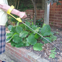Easi-Grip Arm Support Cuff helping a person with arthritis tend to plants in a garden bed, in use.