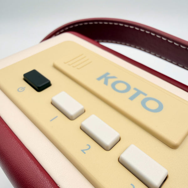OER Easy Radio with power button and two numbered preset buttons, close-up view.