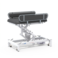 Medi-Plinth electric changing table with MRSA-resistant top, side rails and wheeled frame, side view.