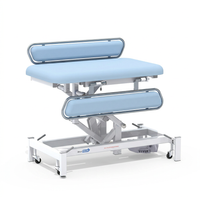 Medi-Plinth electric changing table with MRSA-resistant upholstery, side rails and wheels, front view.