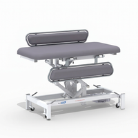 Electric changing table with side rails, MRSA-resistant surface, and white wheeled frame, front angle view.