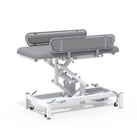 Medi-Plinth electric changing table with metal rails and white wheeled base, NHS-approved, MRSA-resistant, side view.