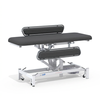 Medi-Plinth electric changing table with MRSA-resistant upholstery and padded cushions, white background, side view.