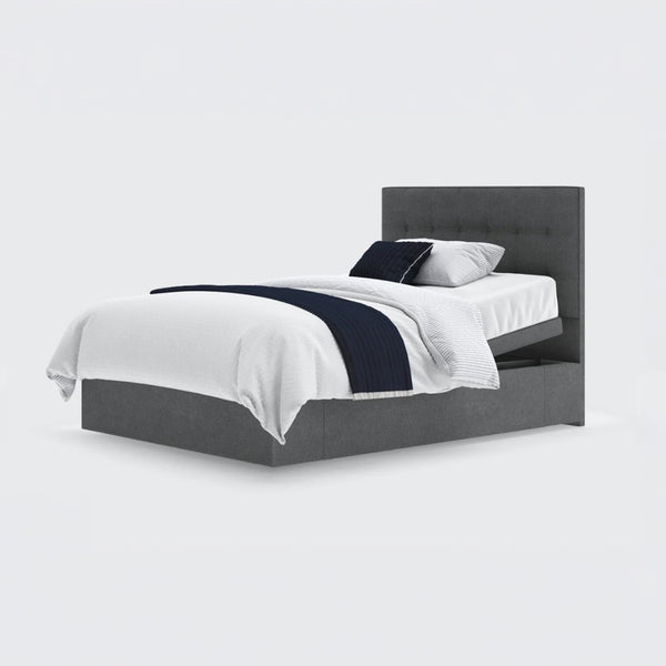 Opera Beds Emerald Motion Adjustable Divan Bed with tufted headboard, white bedding and dark blue accents, front view.