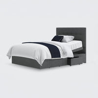 Emerald Motion Adjustable Divan Bed with built-in storage drawers, white bedding and dark blue throw, front view.