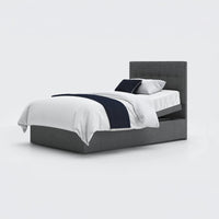 Opera Beds Emerald Motion Adjustable Divan Bed with white bedding, navy throw and pillows, white background, front view.