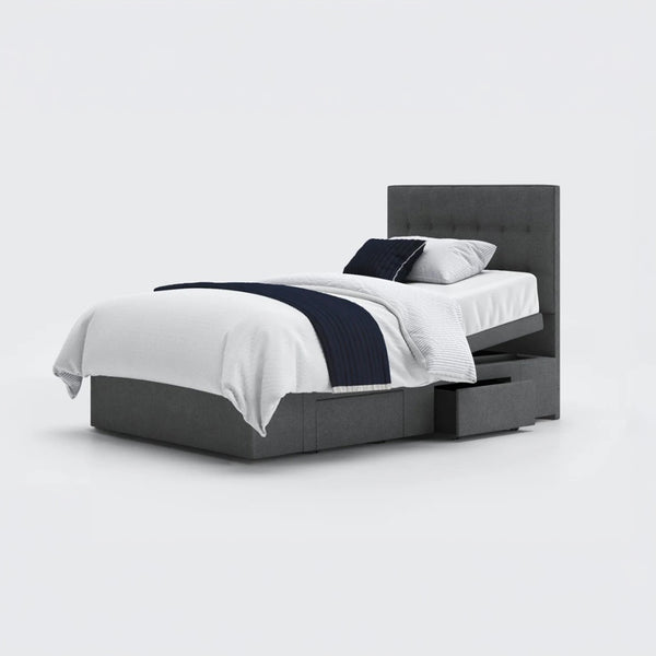 Opera Beds Emerald Motion Adjustable Divan Bed with white bedding, navy throw, two pillows and open storage drawers, front view.